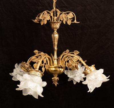 A brass four-branch scrolling