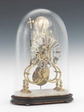 A Brass Skeleton Clock in Glas