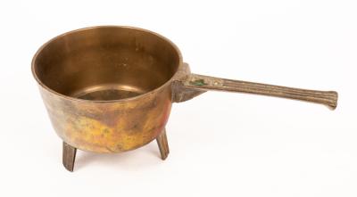 A brass skillet, the handle
