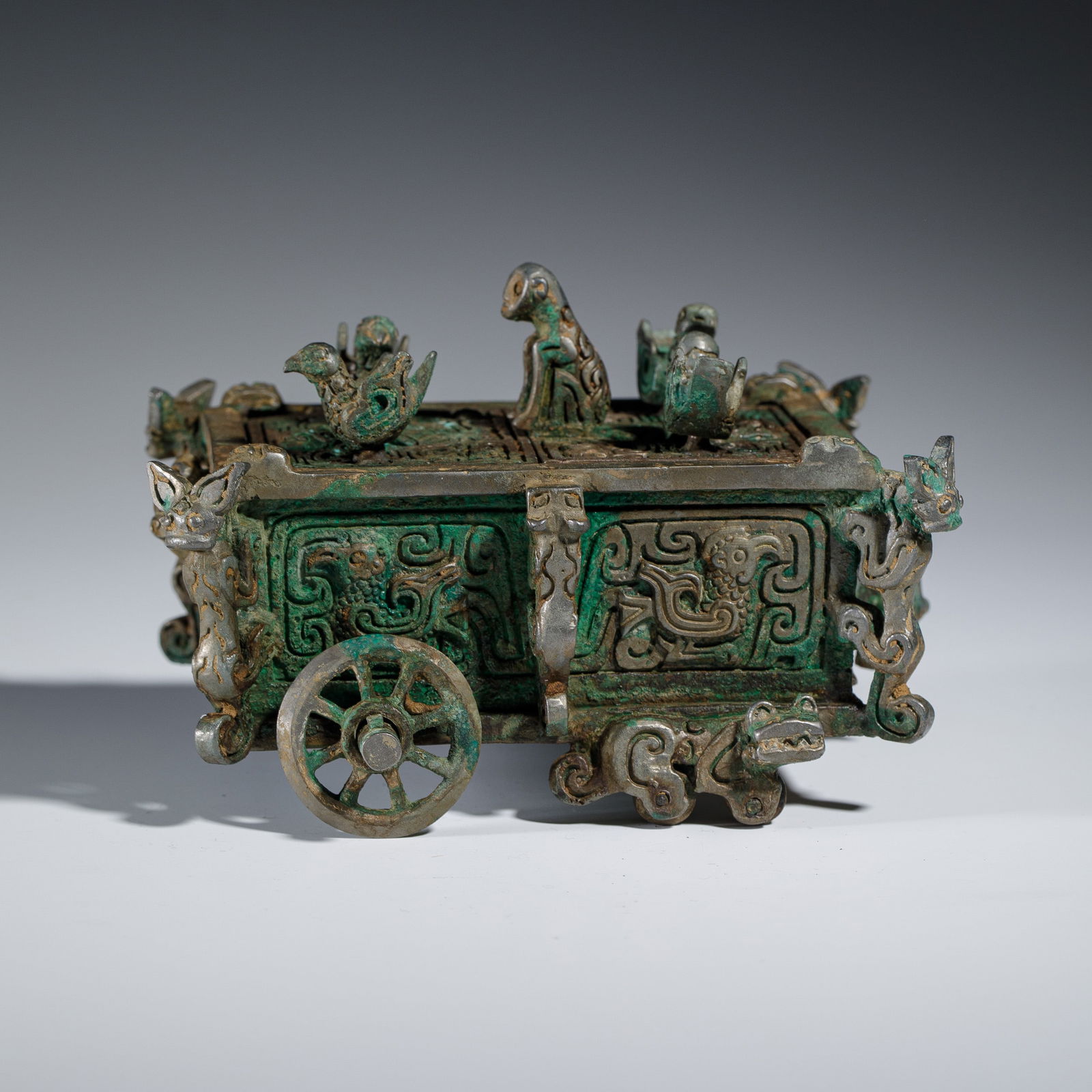 A BRONZE ARTIFACT IN CART - BOX