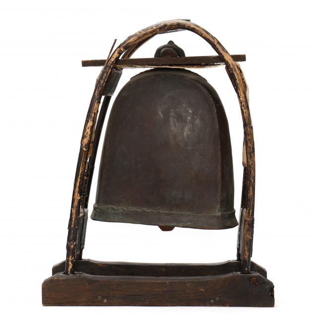 A BRONZE BELL WITH STAND