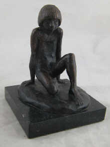 A bronze figure of a naked boy