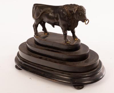 A bronze figure of a bull on a