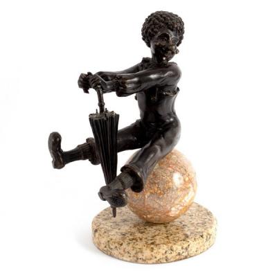 A bronze figure of a clown with