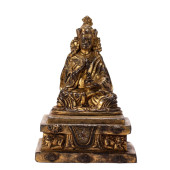 A BRONZE-GILT FIGURE OF BUDDHA