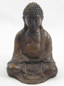 A bronze seated Buddha probably