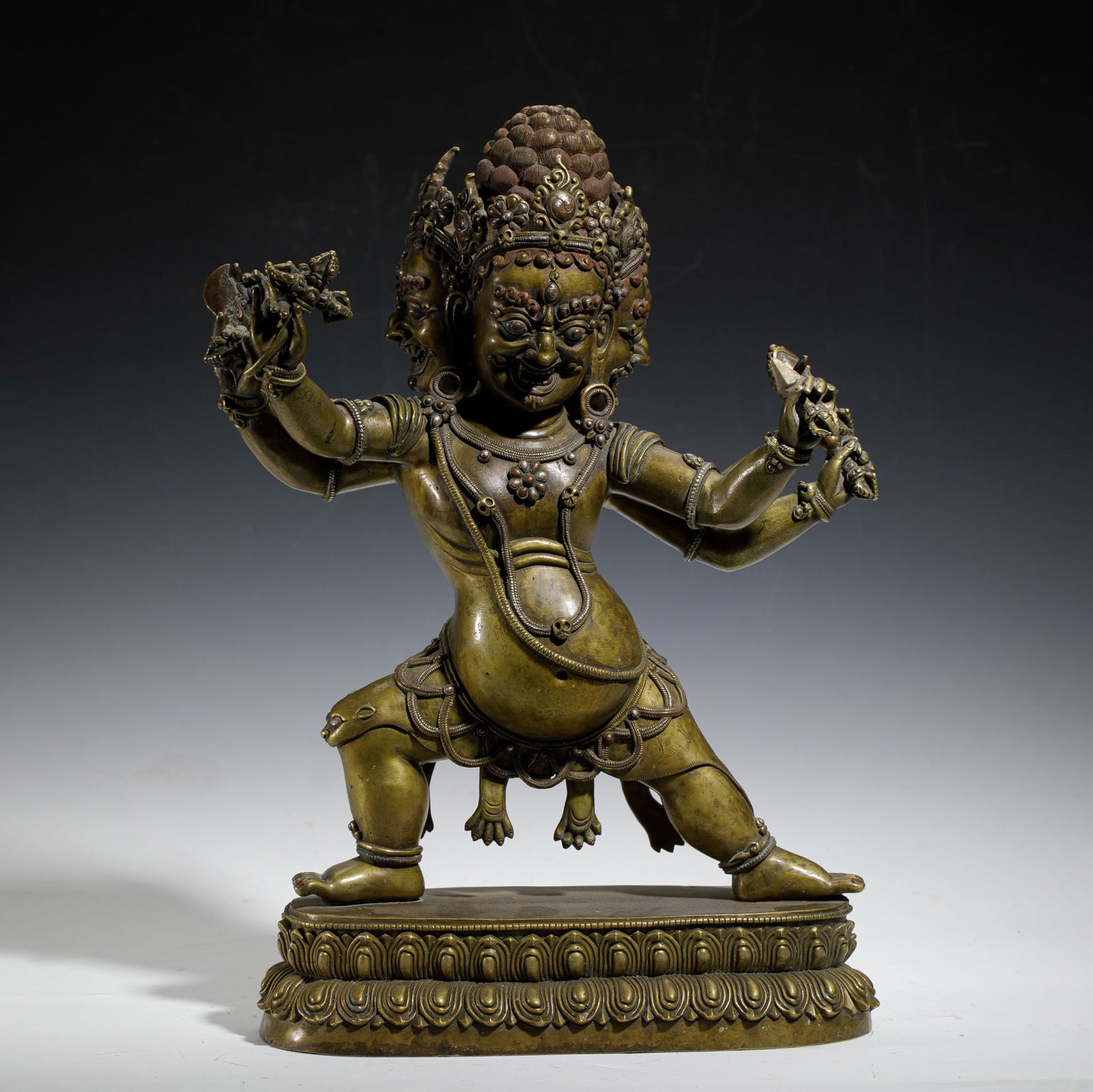 A BRONZE STATUE OF A TIBETAN