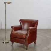 A BROWN LEATHER ARMCHAIR AND R