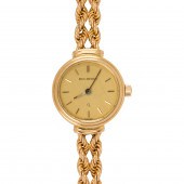 A BUCHERER 18K GOLD WATCH BRAC