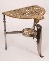 A burnished steel trivet, bras