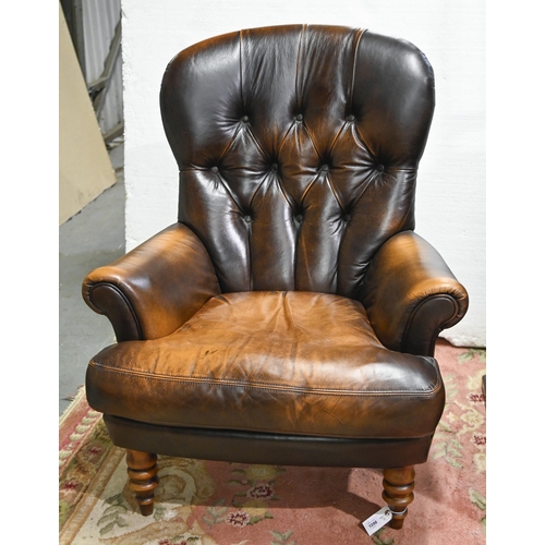 A buttoned back leather armchair,