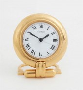 A CARTIER GILT BRASS COLISEE T