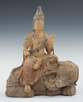 A Carved And Painted Sculpture Of