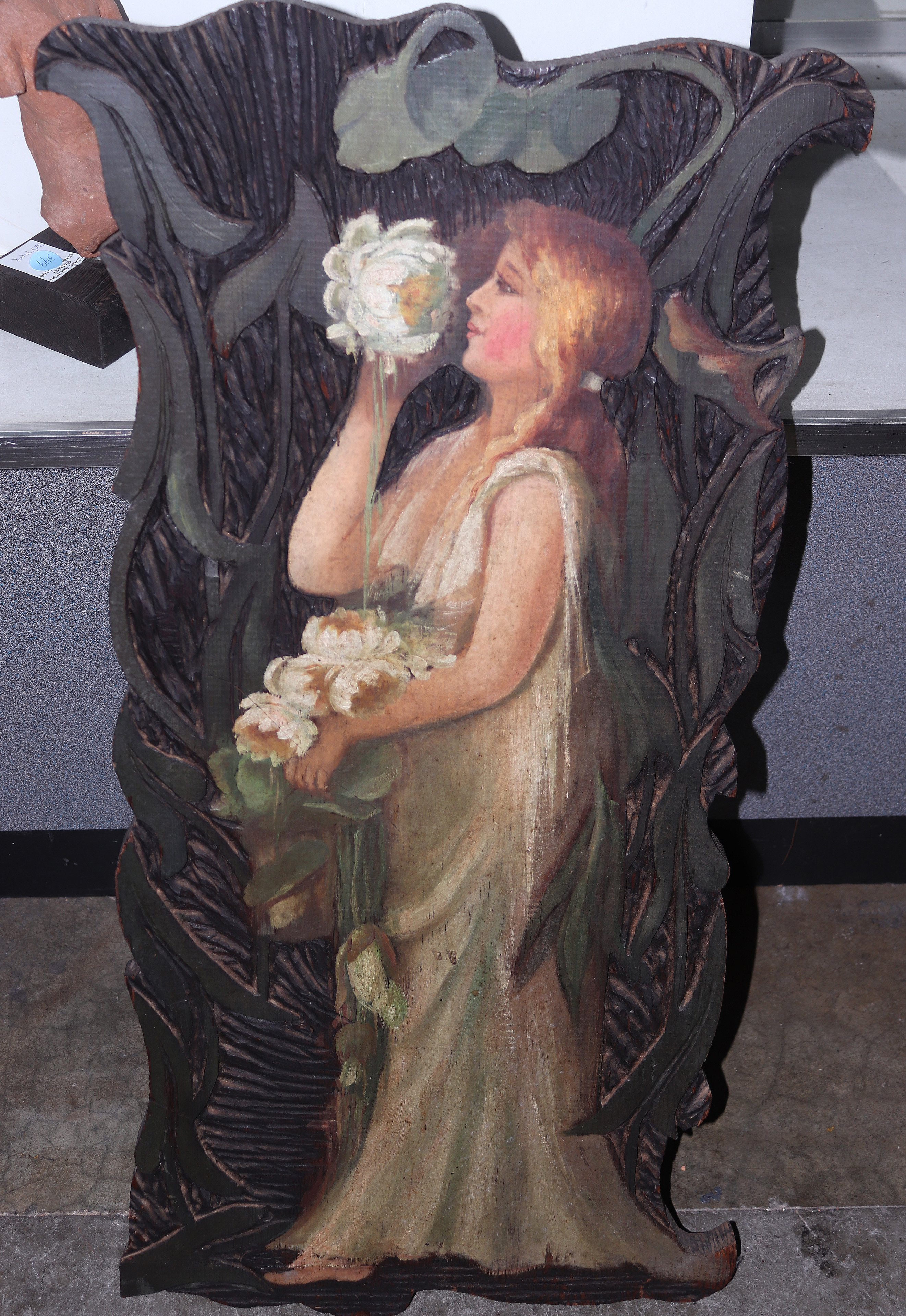 A CARVED AND PAINTED WOOD PANEL A