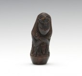 A Carved and Polished Wood Ker
