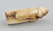 A Carved Antler Netsuke Depict