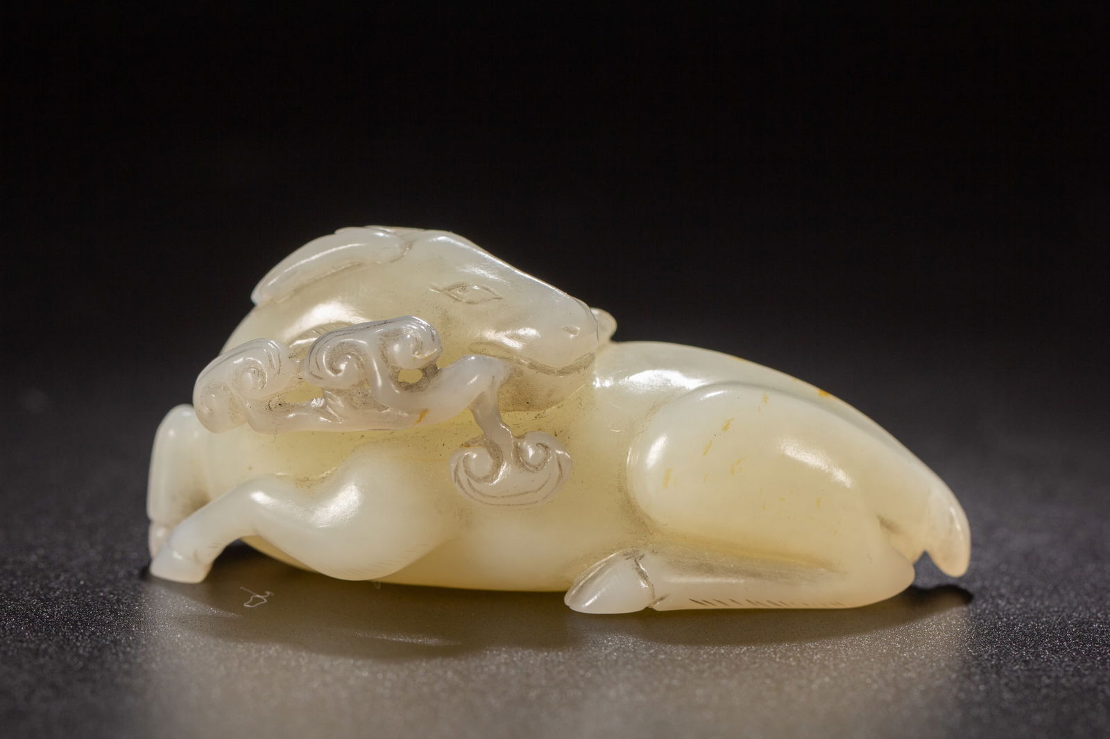 A CARVED ARCHAIC JADE BEASTA CARVED
