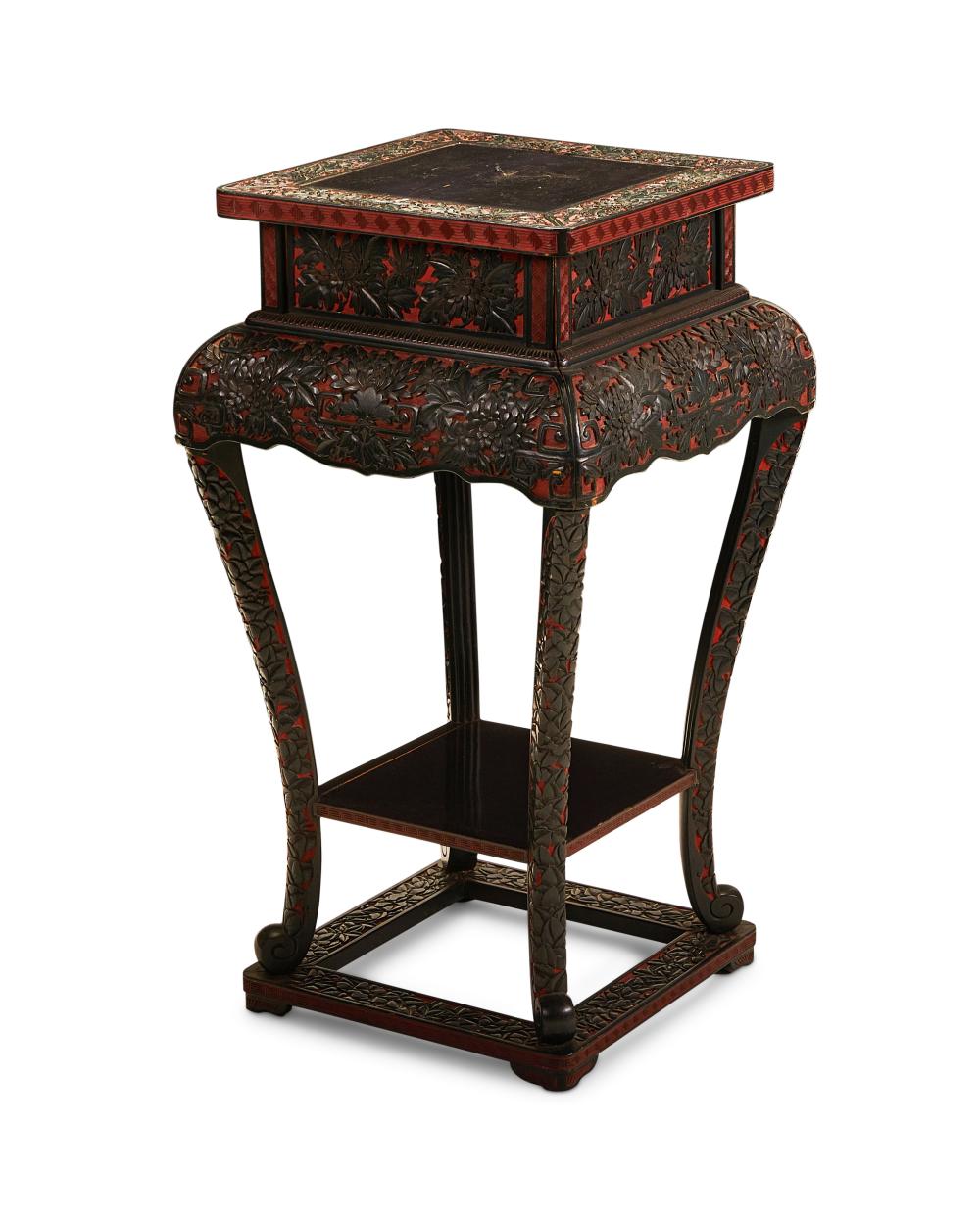 A CARVED BLACK AND RED LACQUER