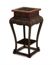 A CARVED BLACK AND RED LACQUER