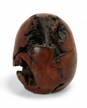 A CARVED BURLWOOD EGG SCULPTUR