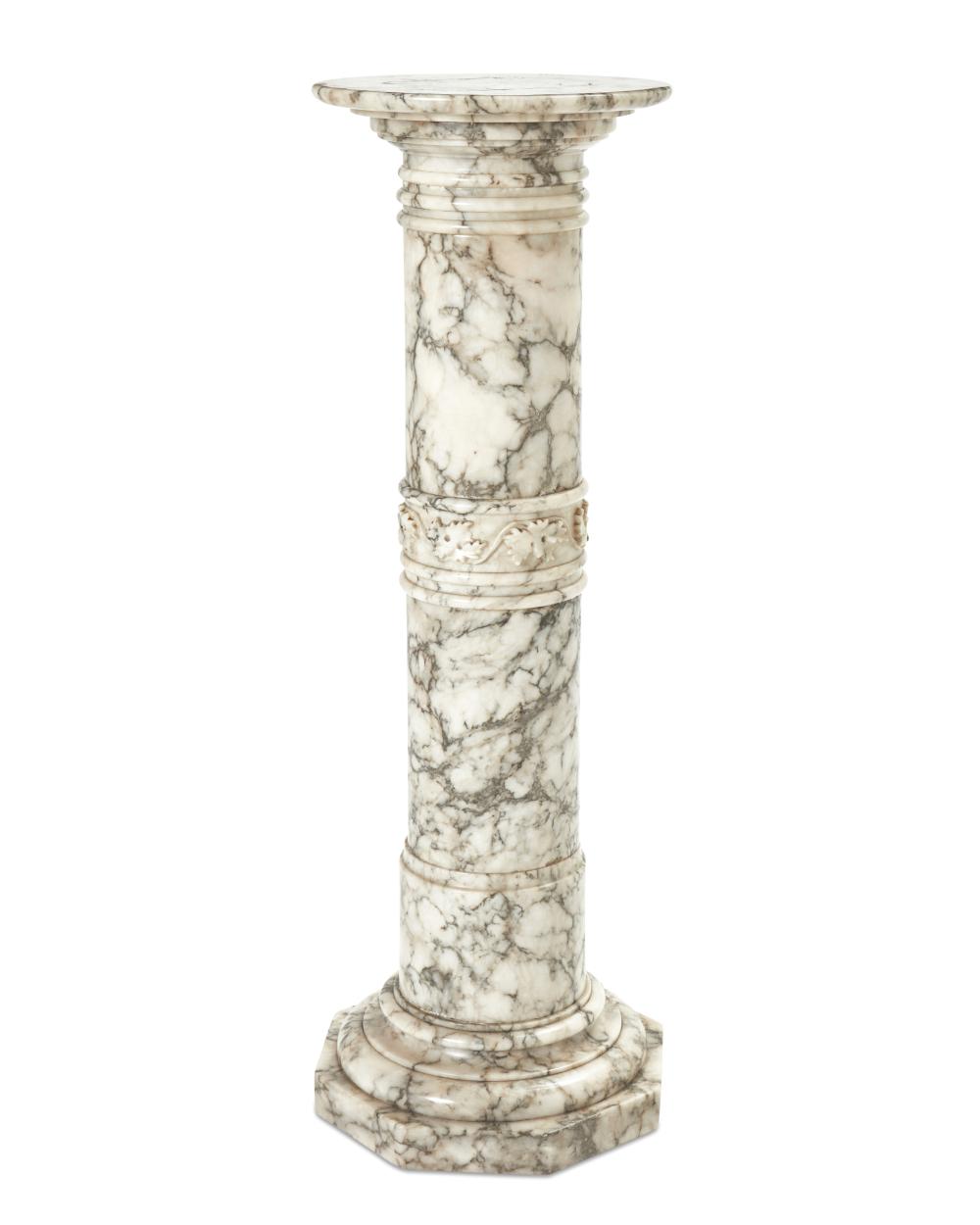 A CARVED CARRERA MARBLE LIGHTED