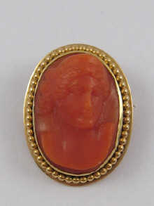 A carved coral cameo mounted as a