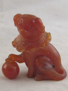 A carved cornelian dog wearing a