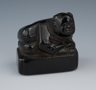 A Carved Ebony Netsuke of a
