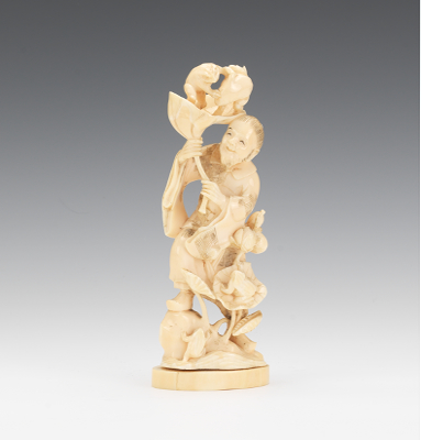 A Carved Figure with Frogs A