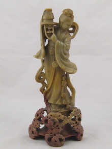 A carved green hardstone figure