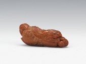 A Carved Horn Figure of a Shis