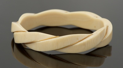 A Carved Ivory and Gold Wire Bangle