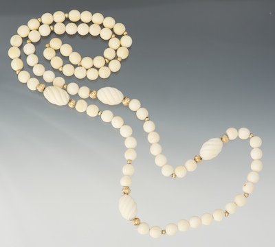 A Carved Ivory and Gold Bead
