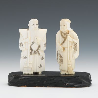 A Carved Ivory Couple with Broom