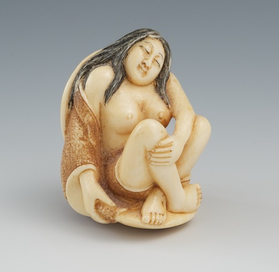 A Carved Ivory Netsuke of a