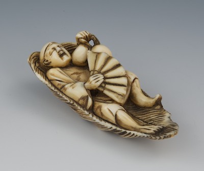 A Carved Ivory Netsuke of a