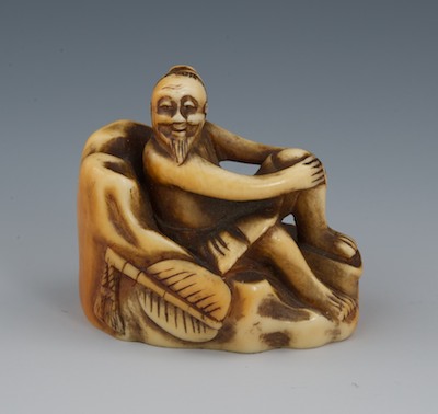 A Carved Ivory Netsuke of a Man