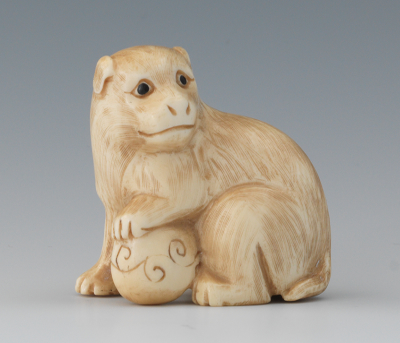 A Carved Ivory Netsuke of a Dog