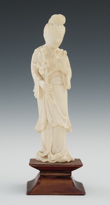 A Carved Ivory Quan Yin Holding