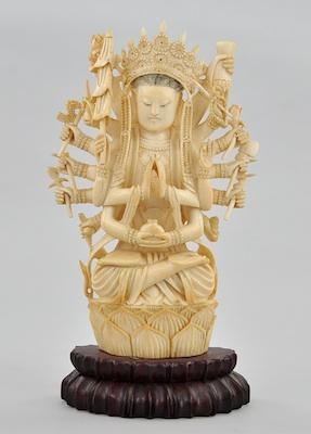 A Carved Ivory Seated Indian