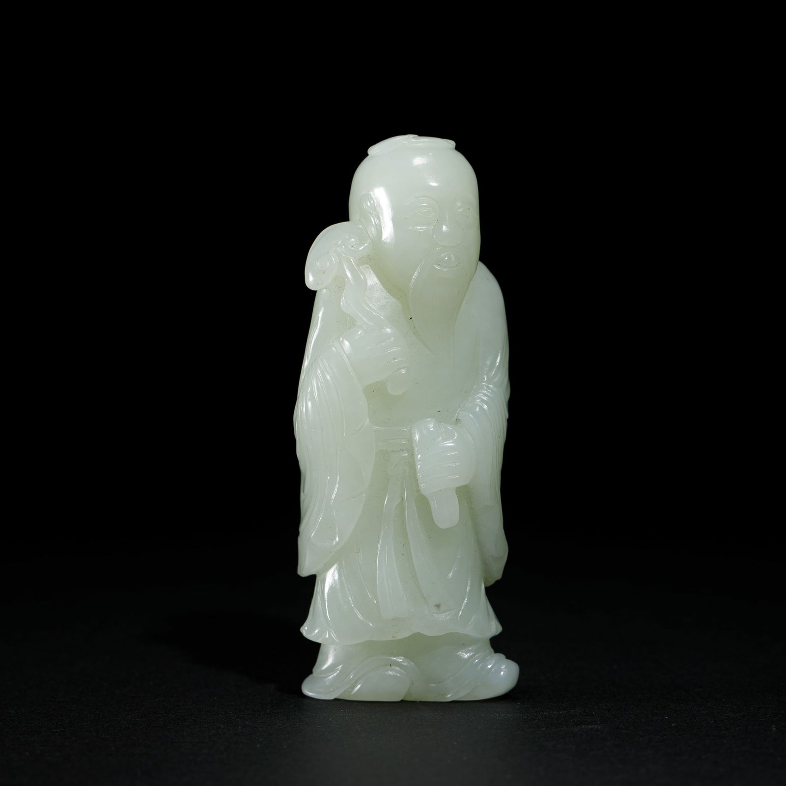 A CARVED JADE FIGURE