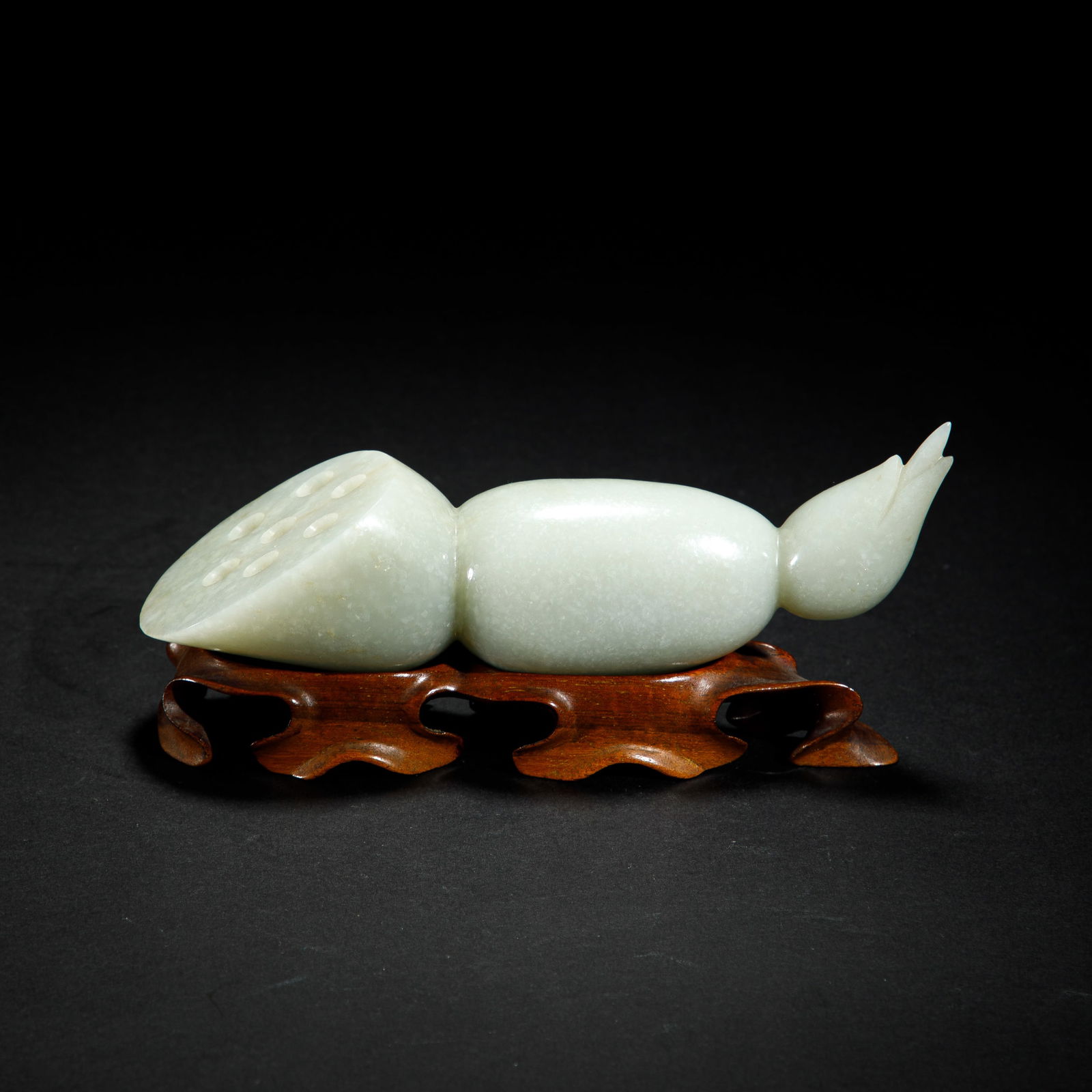 A CARVED JADE LOTUS ROOTA CARVED