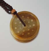 A Carved Jade Pendant on Chord