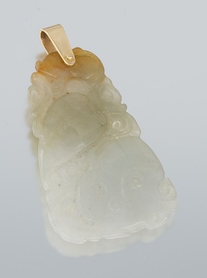 A Carved Jade Pendant With Gold