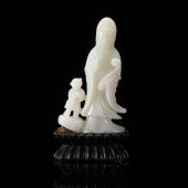 A CARVED JADE STANDING GUANYIN