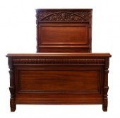 A CARVED MAHOGANY BED FRAME OF