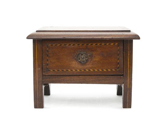 A Carved Mahogany Diminutive