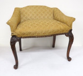 A CARVED MAHOGANY UPHOLSTERED