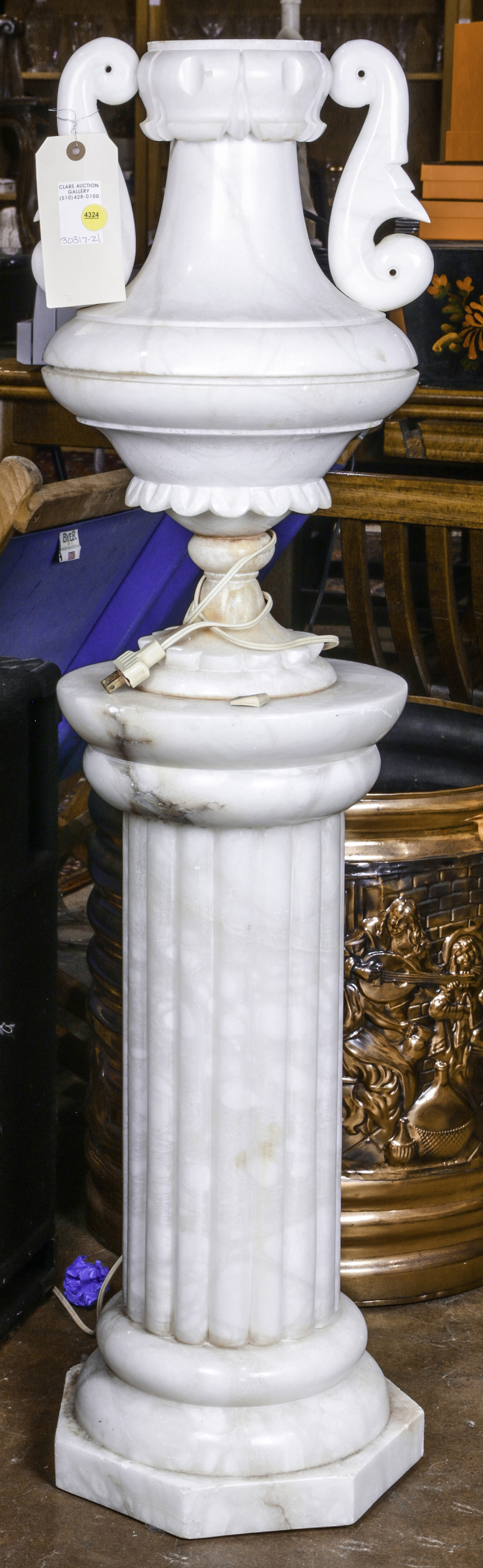 A CARVED MARBLE FLOOR LAMP IN