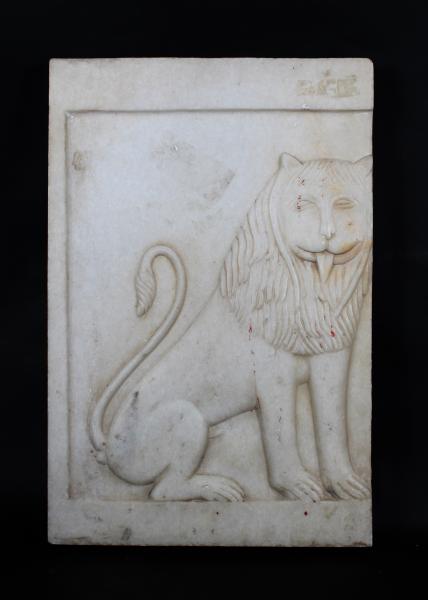 A CARVED MARBLE LION